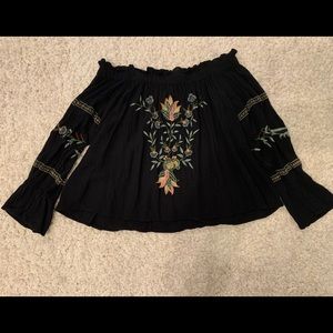 off the shoulder black top with flower patterns